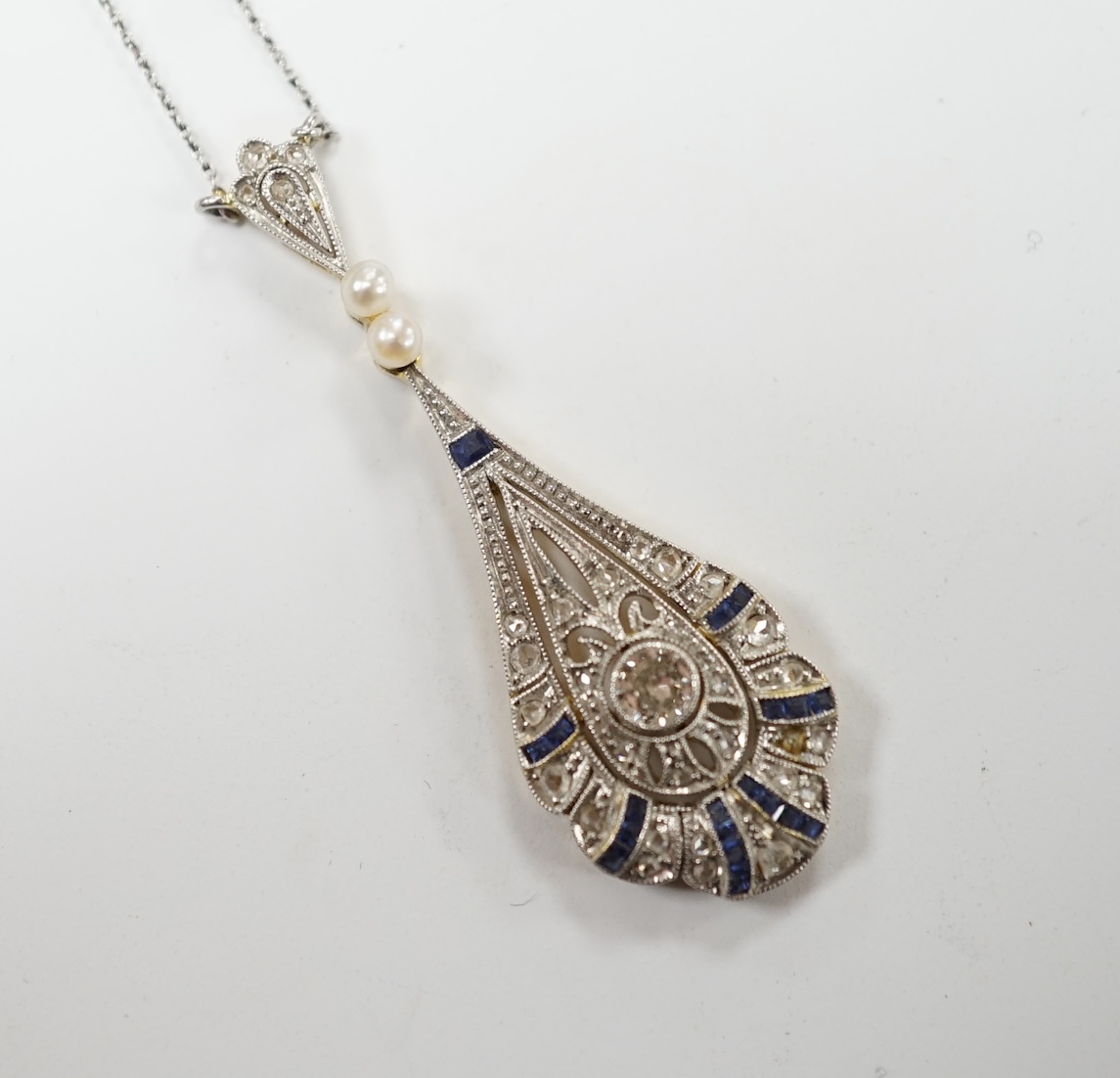 A Belle Époque pierced yellow metal, sapphire, diamond and seed pearl set pendant necklace, overall 50cm, gross weight 4.3 grams. Fair condition.